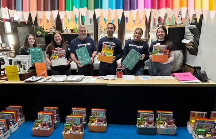  A group of people holding baskets of school supplies